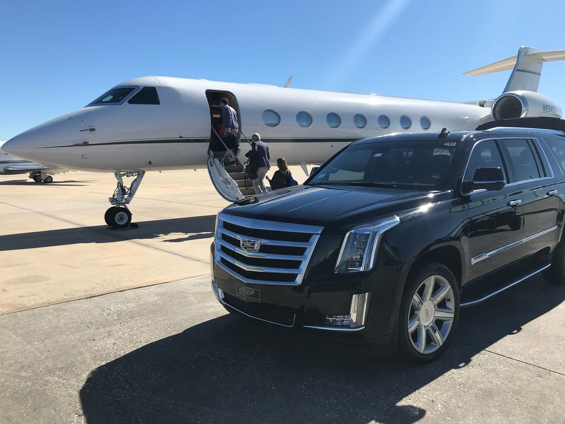 Luxury SUV alongside a private jet